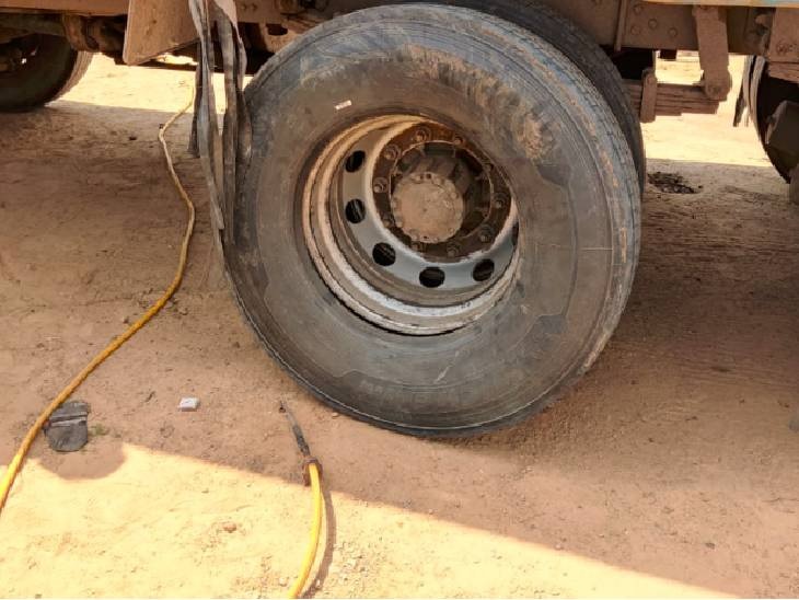 The young man was filling air in the tire of the truck, suddenly the tire burst and the pieces of the young man's body