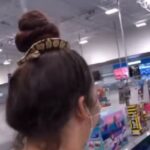 Woman went shopping wearing a rubber band of snake in her hair, video went viral on social media