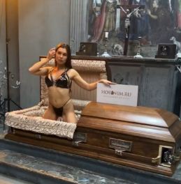 Controversy erupted when a company associated with the funeral featured a bikini girl in an advertisement for the coffin to temper the glamor!