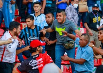 Fans clash during a Mexican soccer league match between the host Queretaro and Atlas from Guadalajara at the Corregidora stadium in Queretaro Mexico Saturday March 5 2022.jpeg
