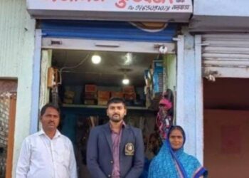 Shooter Gajanan Shahadev Khandagale with his parents in front of the family footwear store at Talwada village Beed