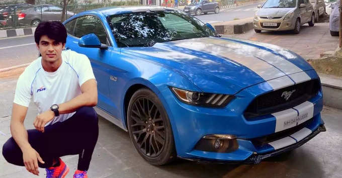 Neeraj rides in a blue Mustang