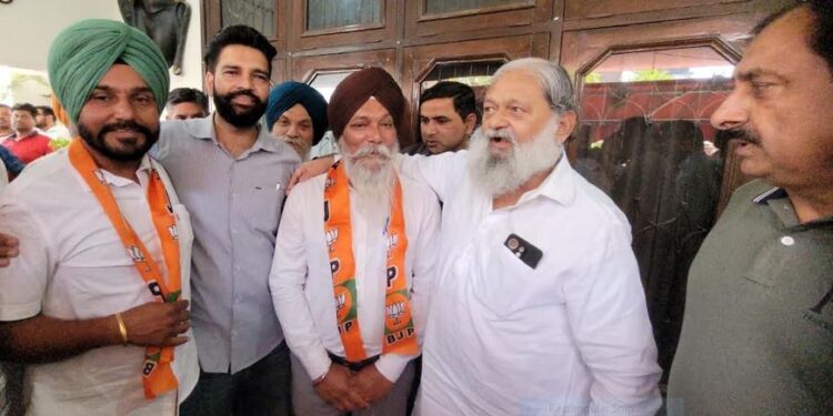 Two sarpanches impressed by Anil Vij's working style join BJP