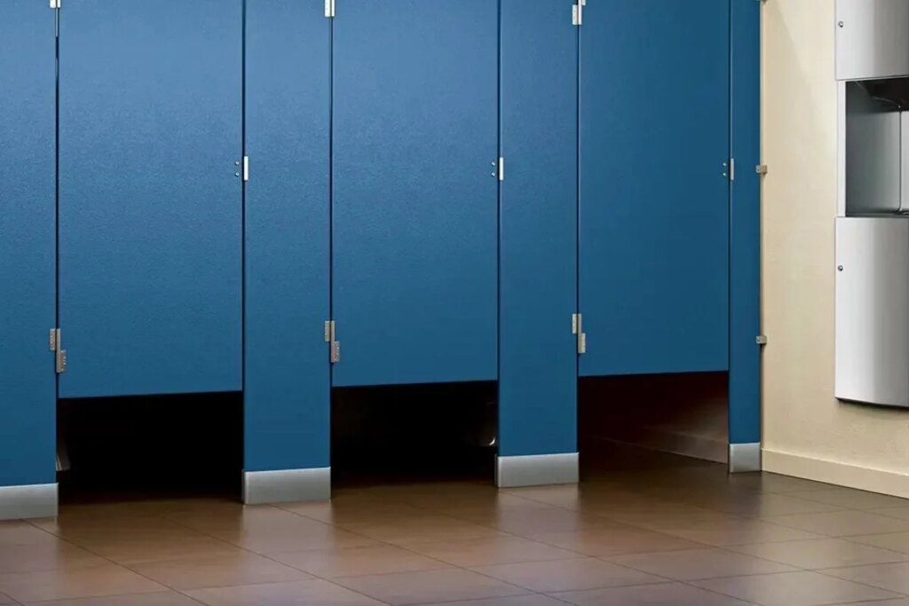 Why is there a gap below the toilet doors of cinema halls and shopping malls?