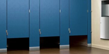 Why is there a gap below the toilet doors of cinema halls and shopping malls?